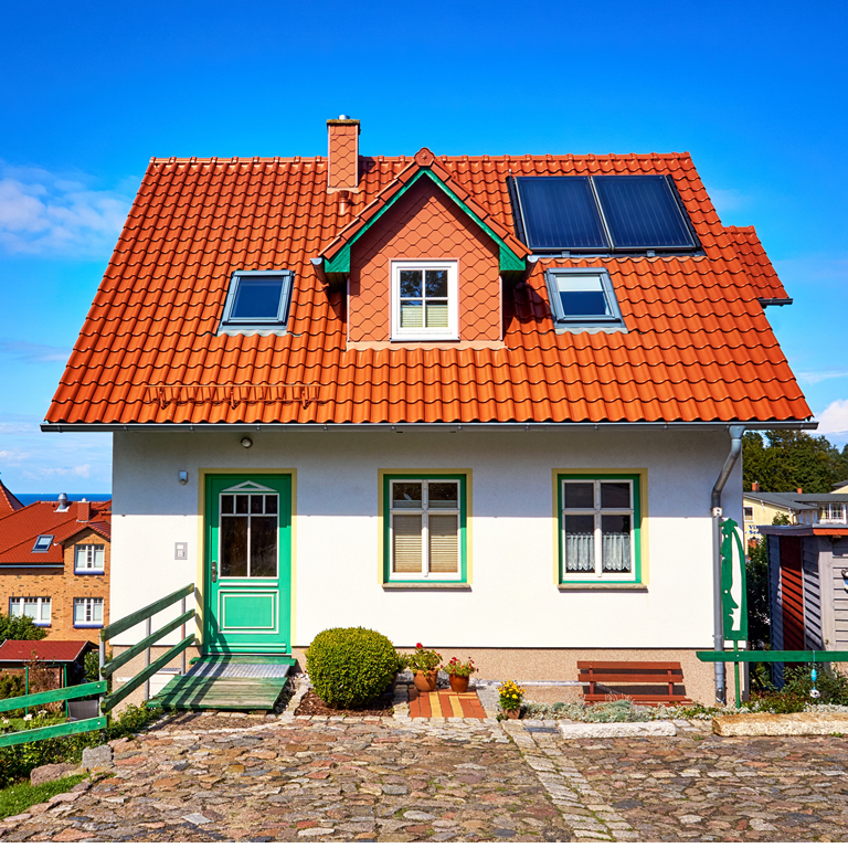 New modern single family house with red roof tiles and solar panels. Living overlooking the Baltic Sea in Lohme on the island of Rügen